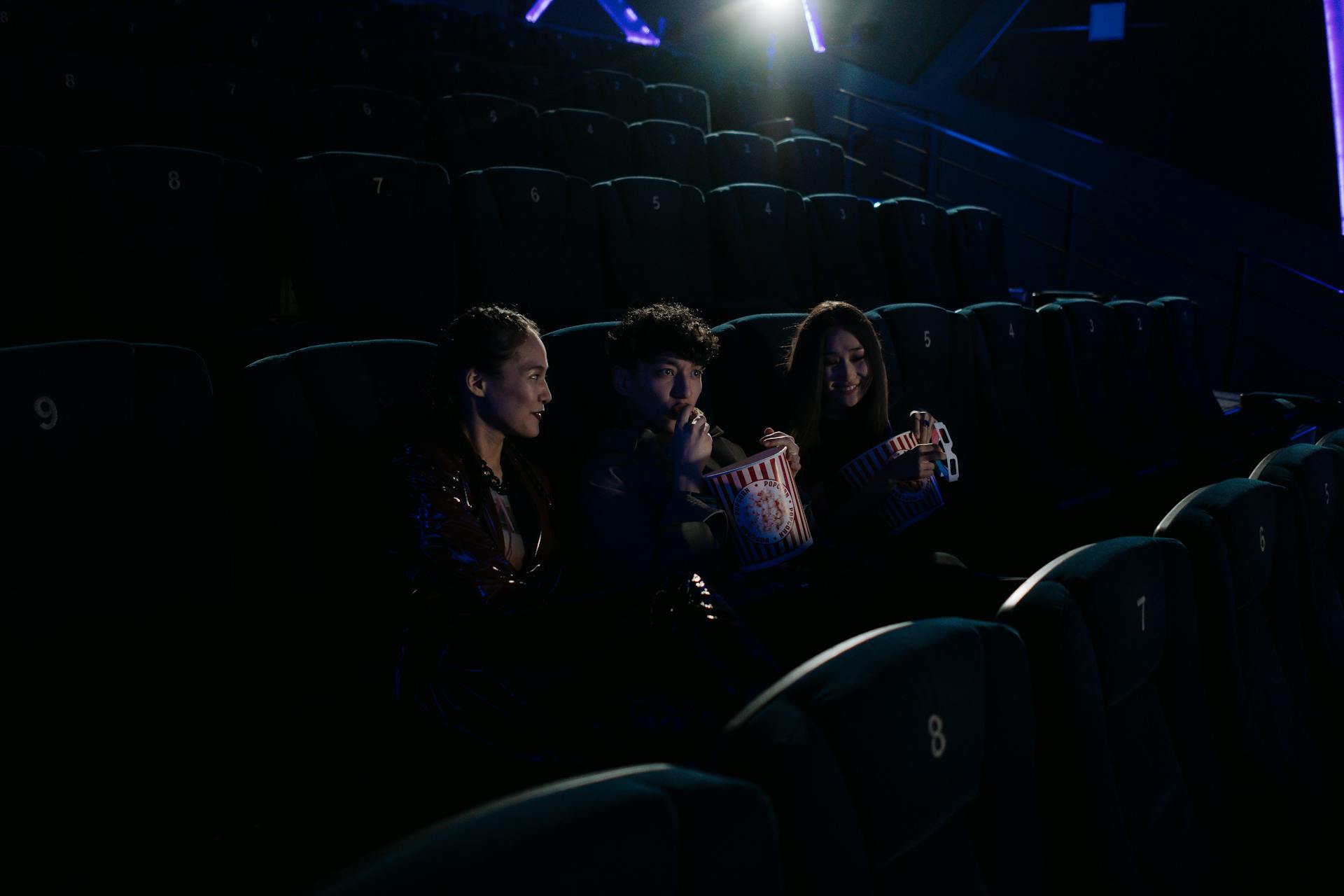 An image of people eating popcorn in the cinema